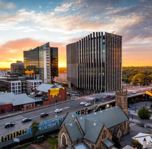 Traffic crossing the Morphett Street Bridge in Adelaide City at sunset