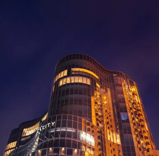 Low angle view of Eos by SkyCity illuminated at night