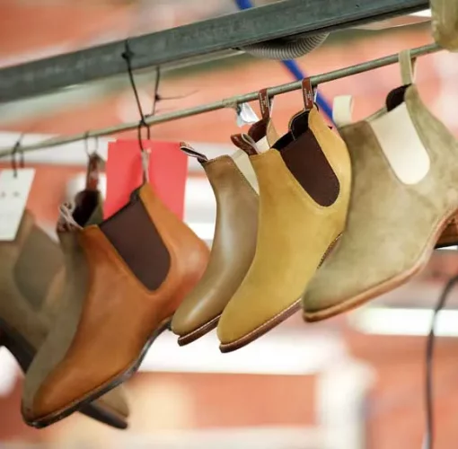 Hanging row of R.M.Williams Craftsman boots in different leathers and colours