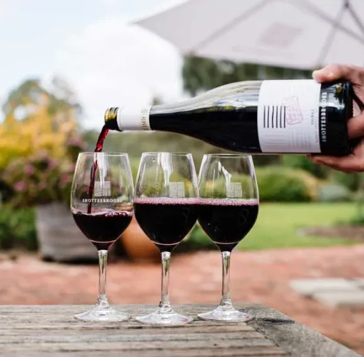 Three glasses of red wine being poured in the Shottesbrooke beer garden